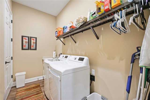 washroom with independent washer and dryer and hardwood / wood-style floors