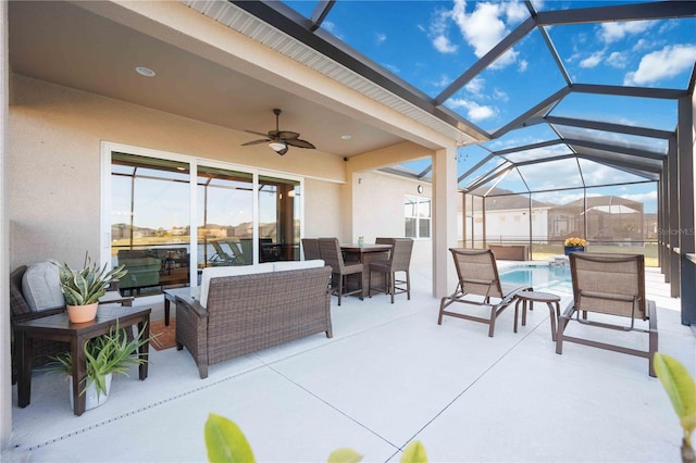 view of patio / terrace featuring ceiling fan, an outdoor hangout area, and a lanai