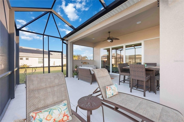 sunroom featuring ceiling fan