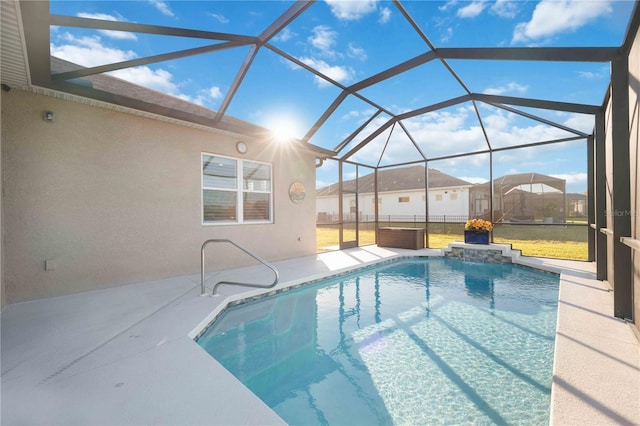 view of swimming pool featuring a patio, a jacuzzi, and glass enclosure