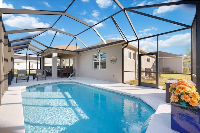 view of swimming pool featuring a patio area and glass enclosure