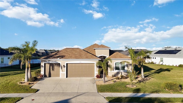 view of front of home with a garage and a front yard