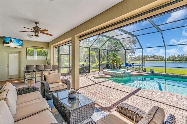 view of swimming pool featuring a water view, a pool with connected hot tub, and a ceiling fan