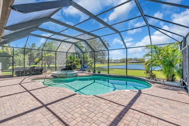 view of swimming pool with a pool with connected hot tub, a patio area, and a lanai