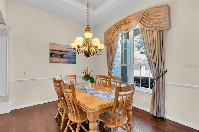 dining space with dark wood-style flooring, a notable chandelier, and baseboards