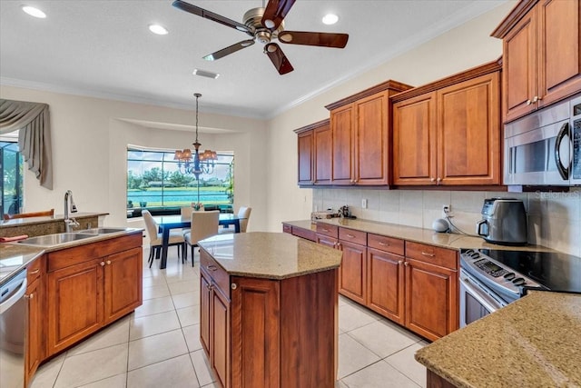 kitchen featuring visible vents, decorative backsplash, stainless steel appliances, crown molding, and a sink