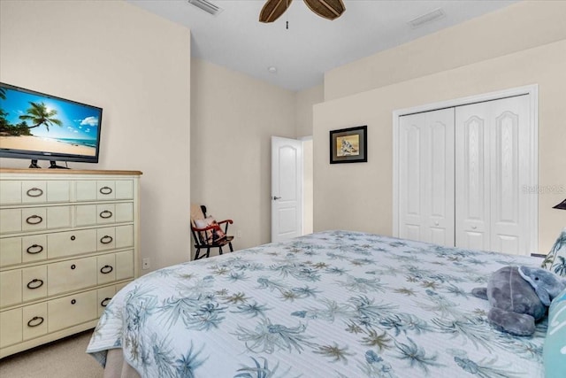 bedroom with a ceiling fan, visible vents, a closet, and light colored carpet