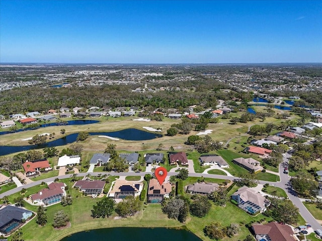 birds eye view of property featuring a water view, a residential view, and golf course view