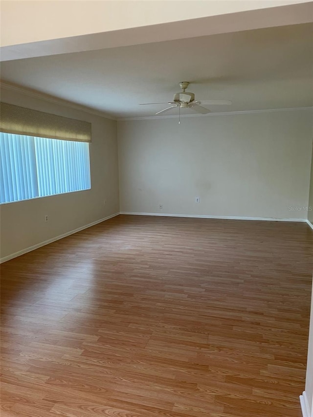 spare room with ornamental molding, light hardwood / wood-style floors, and ceiling fan