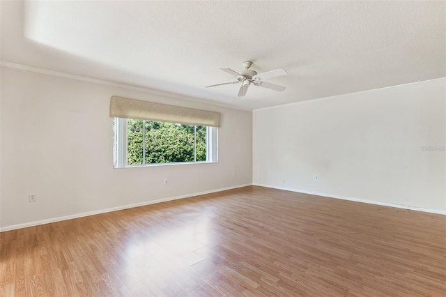 unfurnished room featuring ceiling fan, ornamental molding, hardwood / wood-style floors, and a textured ceiling