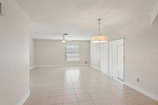 tiled spare room featuring ceiling fan