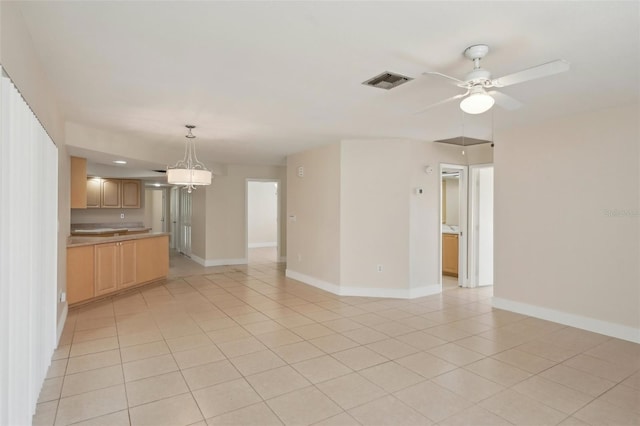 interior space featuring light tile patterned flooring and ceiling fan