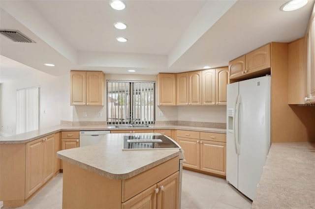 kitchen with light brown cabinetry, sink, a center island, a raised ceiling, and white appliances