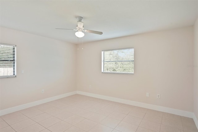 unfurnished room with ceiling fan and a healthy amount of sunlight