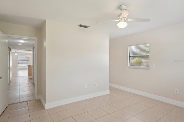 tiled empty room with ceiling fan