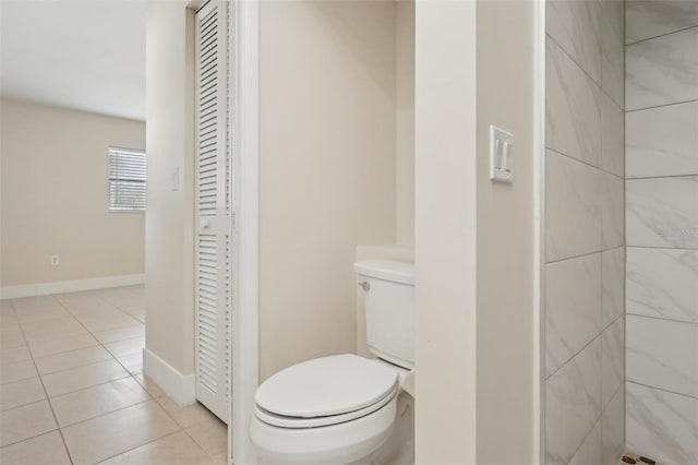 bathroom with tile patterned flooring and toilet