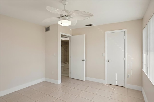 unfurnished bedroom featuring light tile patterned floors and ceiling fan