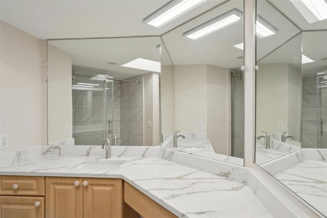 bathroom featuring vanity and an enclosed shower