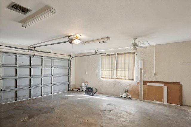 garage with a garage door opener and ceiling fan