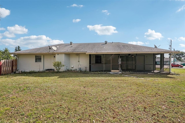 back of house with a yard and a sunroom