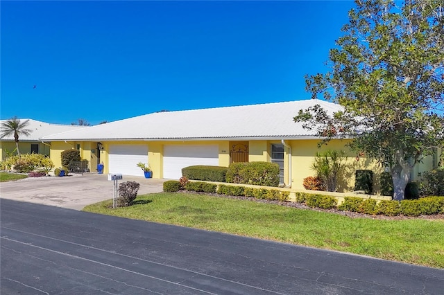 ranch-style house with a garage and a front lawn