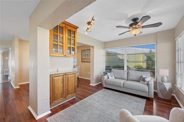 living room with ceiling fan and dark hardwood / wood-style flooring