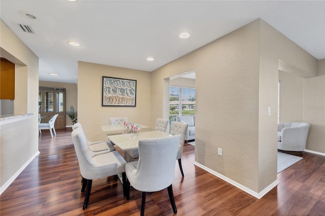 dining space featuring dark hardwood / wood-style floors