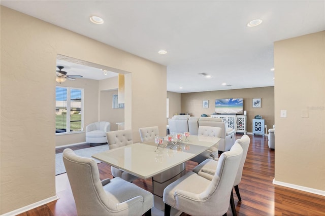 dining area with dark wood-type flooring and ceiling fan