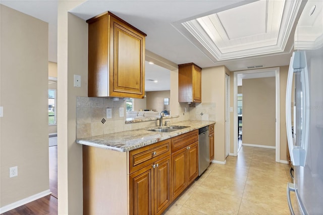 kitchen with sink, backsplash, white fridge, stainless steel dishwasher, and light stone counters