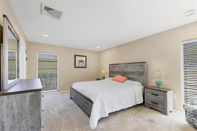 carpeted bedroom featuring multiple windows