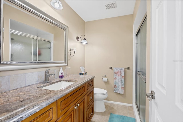 bathroom with tile patterned flooring, vanity, and an enclosed shower