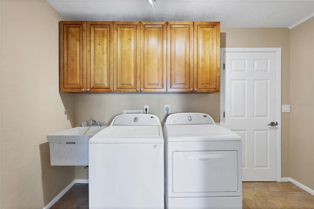 laundry room featuring cabinets, washer and dryer, sink, and light tile patterned floors