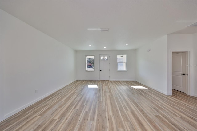 unfurnished living room with light hardwood / wood-style flooring