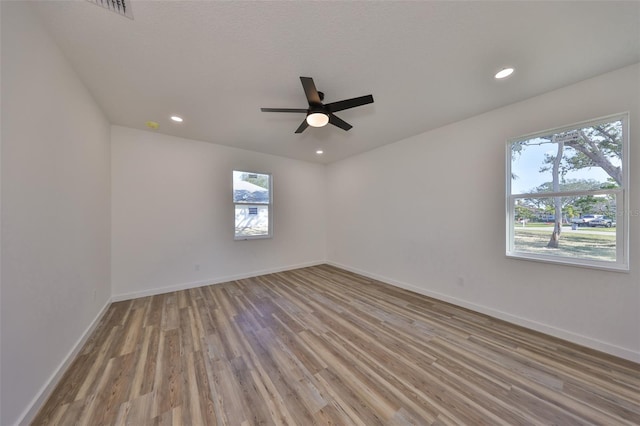 empty room with light hardwood / wood-style floors and ceiling fan