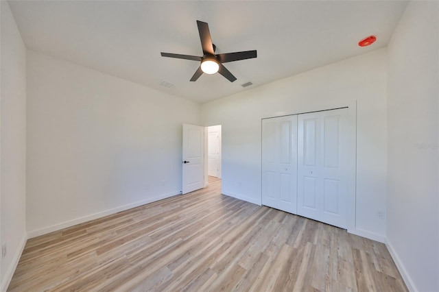 unfurnished bedroom featuring a closet, ceiling fan, and light wood-type flooring