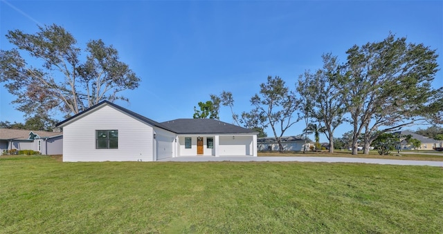 ranch-style home featuring a garage and a front lawn