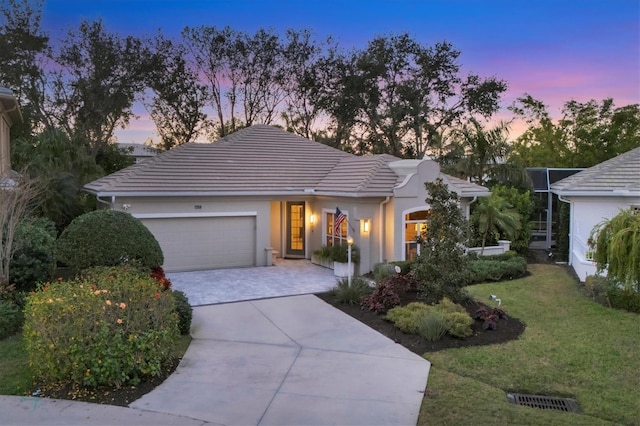 view of front facade featuring a garage and a lawn