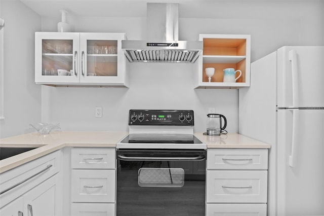 kitchen with range with electric cooktop, white refrigerator, wood-type flooring, white cabinets, and island exhaust hood