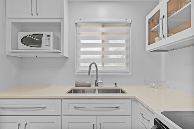 kitchen featuring white cabinetry and sink