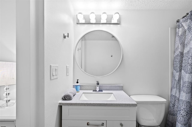 4126 Heron Way Unit B113, Bradenton, FL 34205 - full bathroom with vanity, a textured ceiling, and toilet
