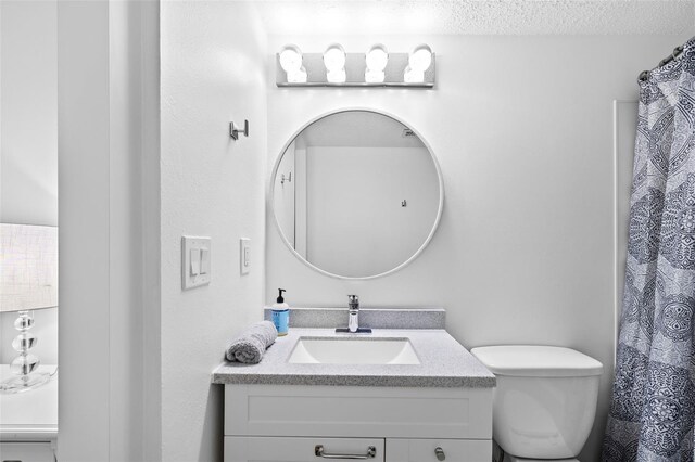 4126 Heron Way Unit B113, Bradenton, FL 34205 - full bathroom with vanity, a textured ceiling, and toilet