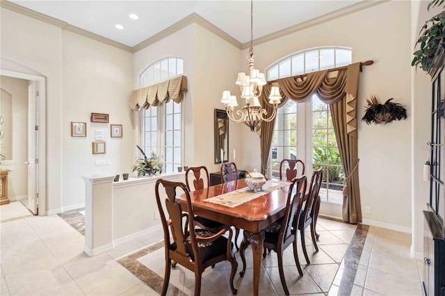 dining room with crown molding, a towering ceiling, a chandelier, and a wealth of natural light