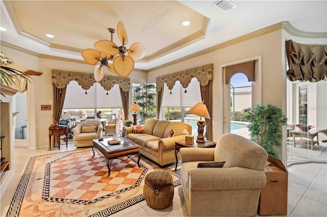 sunroom with ceiling fan and a raised ceiling