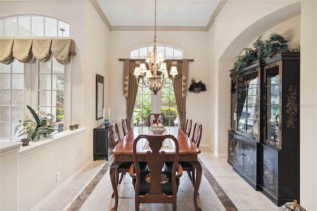 tiled dining area featuring ornamental molding, a towering ceiling, and a notable chandelier