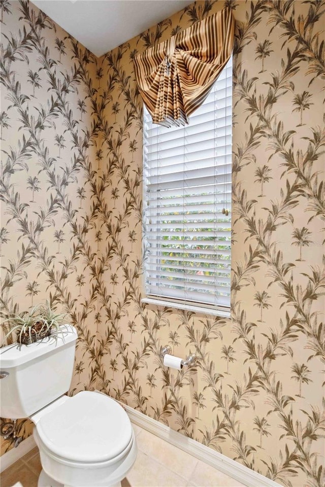 bathroom with toilet and tile patterned flooring