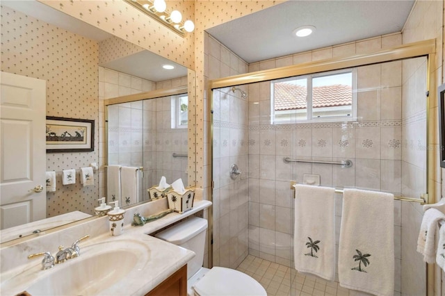 bathroom with vanity, toilet, and walk in shower