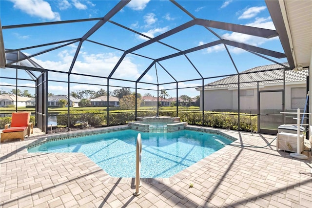 view of pool featuring a lanai, a patio, a water view, and an in ground hot tub