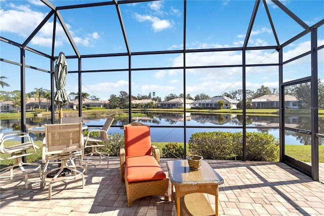 view of patio / terrace featuring a water view and a lanai