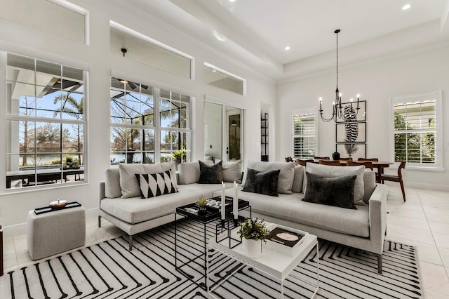 living room with a towering ceiling, light tile patterned floors, and a notable chandelier