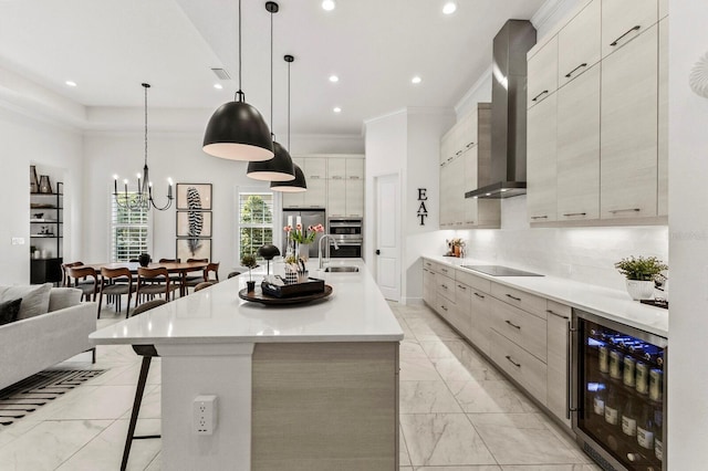 kitchen featuring a breakfast bar area, wine cooler, hanging light fixtures, wall chimney exhaust hood, and a spacious island